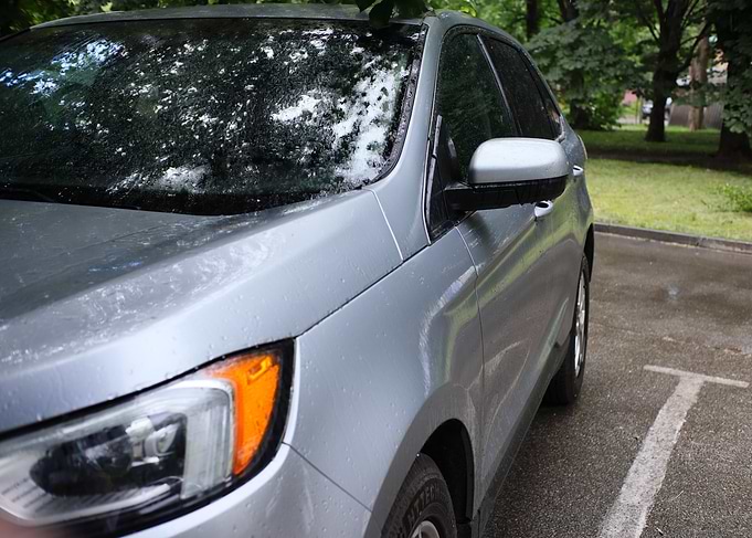 Silver SUV parked on rainy day