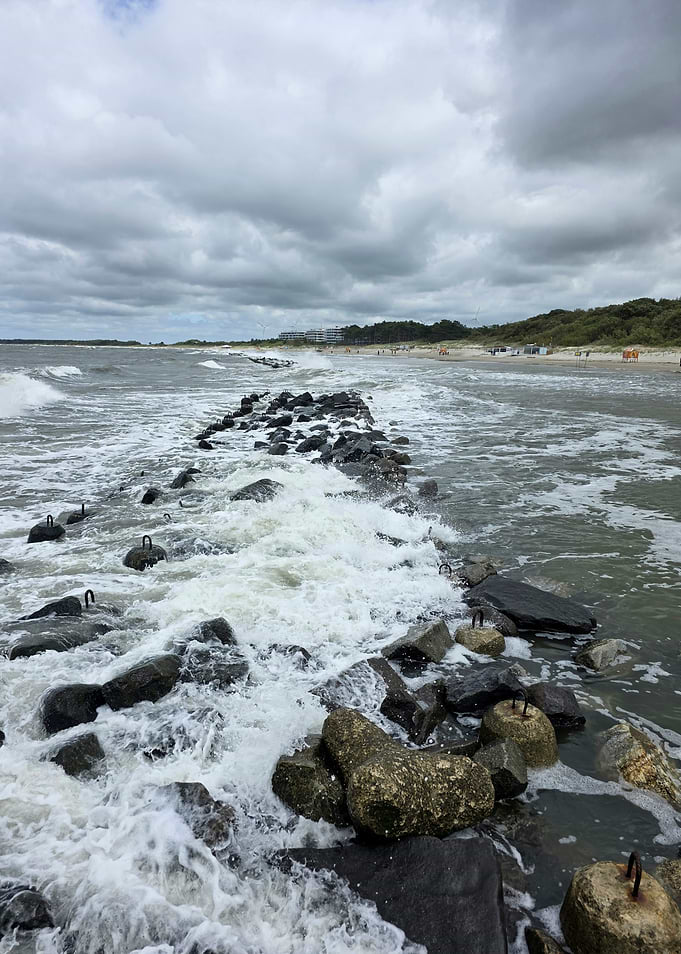 Waves Crashing Over Coastal Breakwater