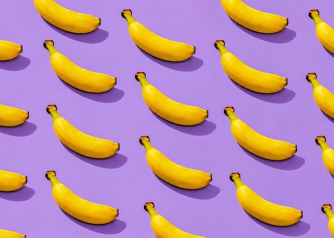 Vibrant Banana Pattern on Purple Background