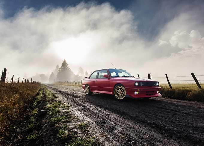 Red BMW E30 M3 on Country Road
