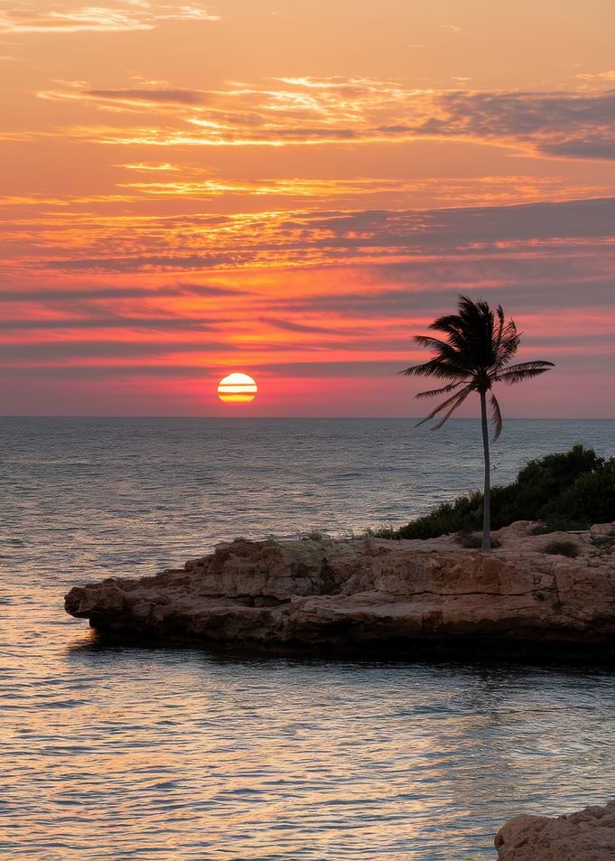 Tropical Sunset Over Rocky Coastline