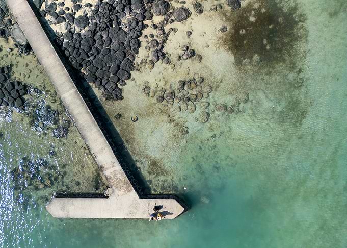 Aerial view of pier in turquoise water