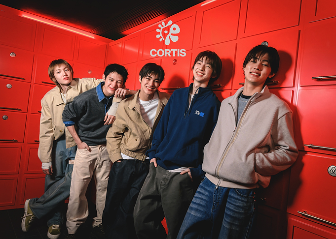 Cortis Posing Against Red Lockers