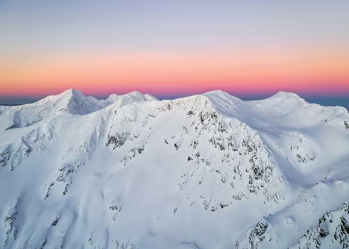 Snowy Mountain Peaks at Sunset