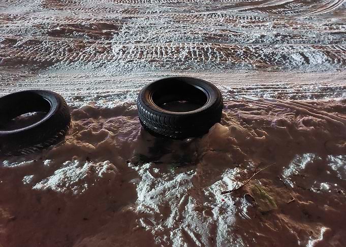 Two Car Tires in Snowy Terrain