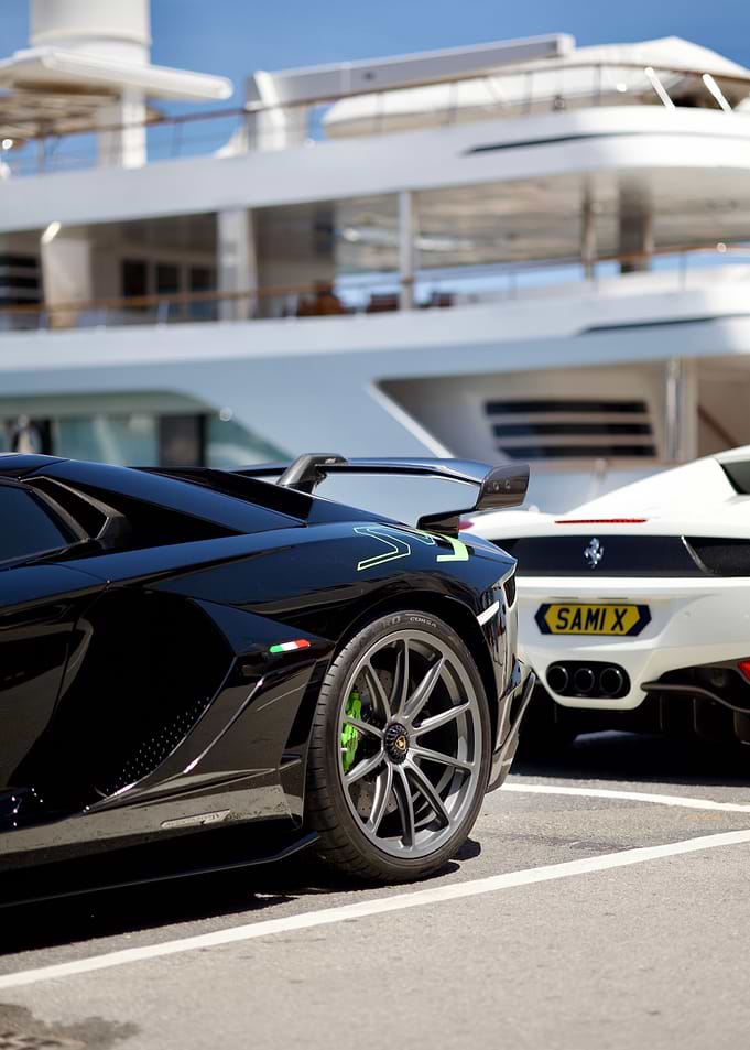 Luxury Supercars Parked by Yacht