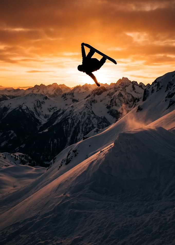 Snowboarder Jumping at Sunset