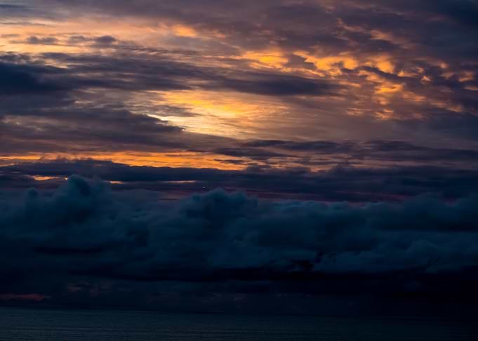 Dramatic Sunset Over Dark Ocean