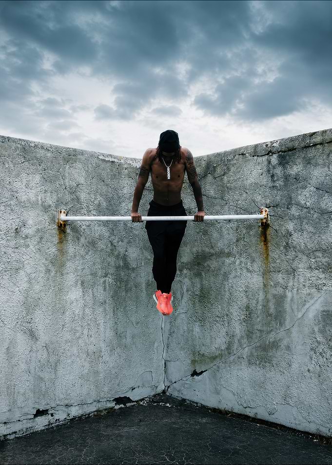 Man performing pull-ups outdoors