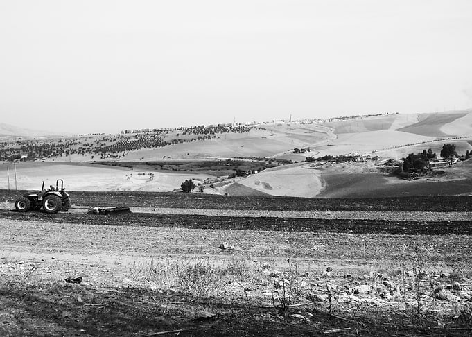 Tractor Plowing Field in Rural Landscape