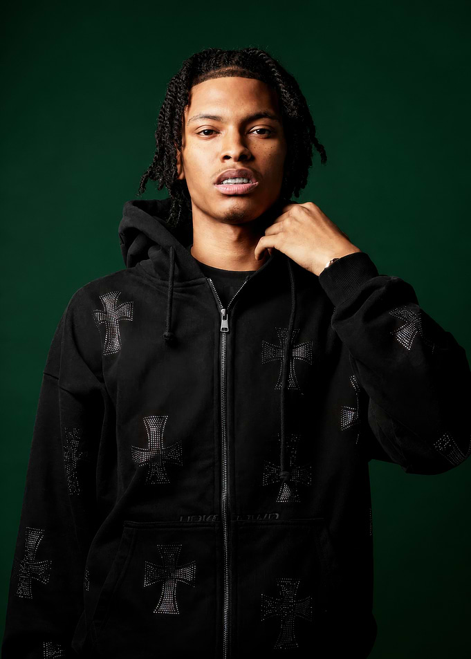 Young man in black cross hoodie
