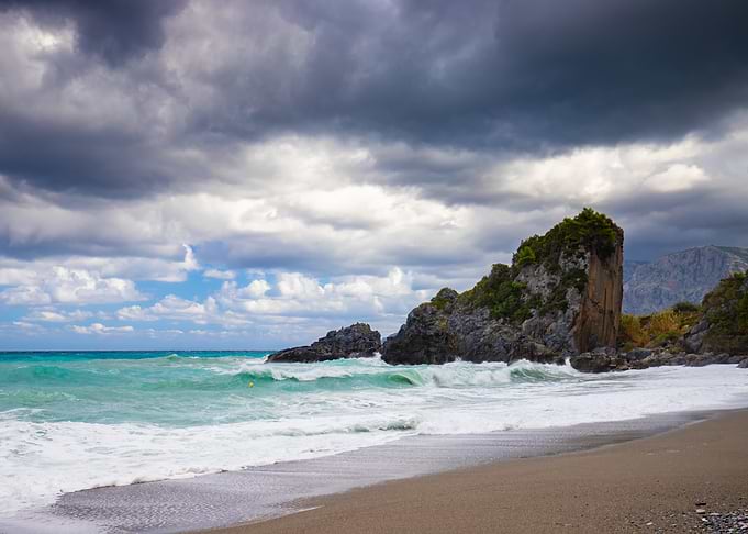 Dramatic Rocky Beach Under Stormy Skies