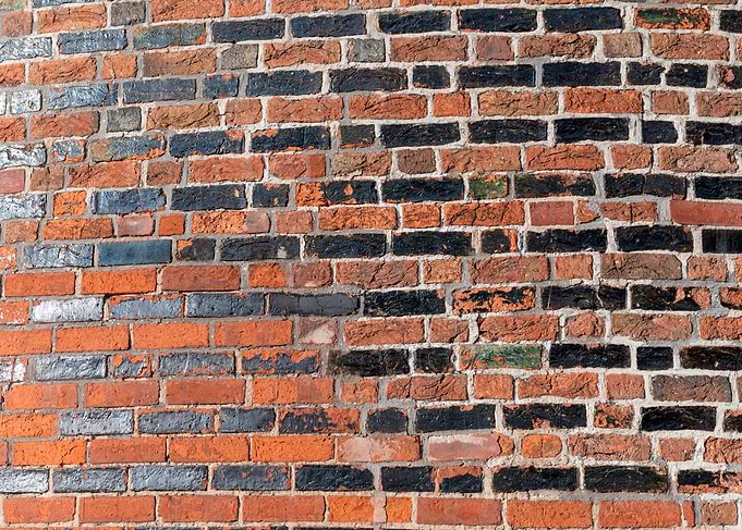 Textured Red and Black Brick Wall