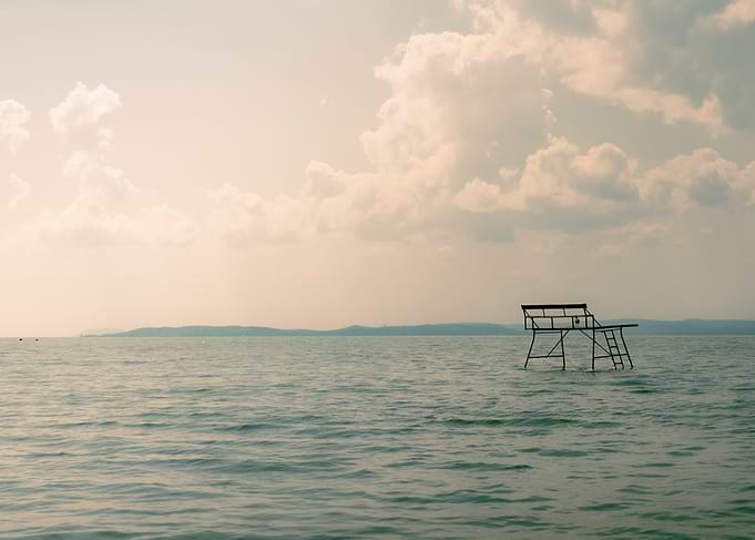 Lonely bench in the middle of lake