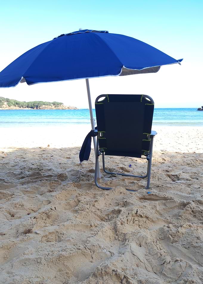 Beach Chair Under Blue Umbrella