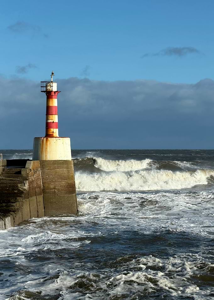 Amble Harbour Lighthouse in Stormy Sea
