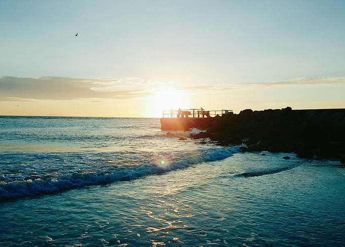 Sun and clouds over a coastal area