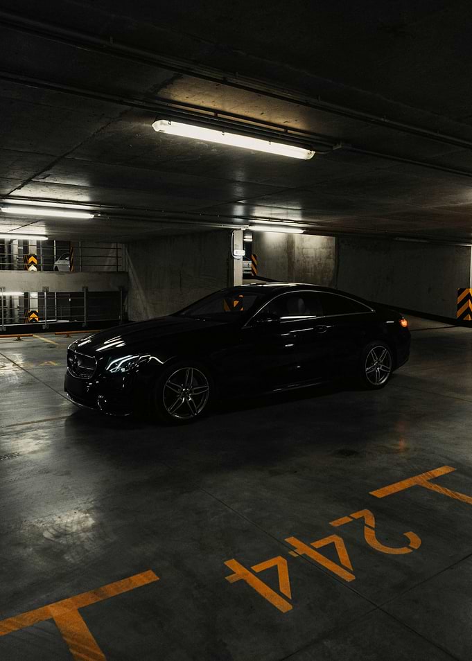 Black Mercedes-Benz Coupe in Parking Garage