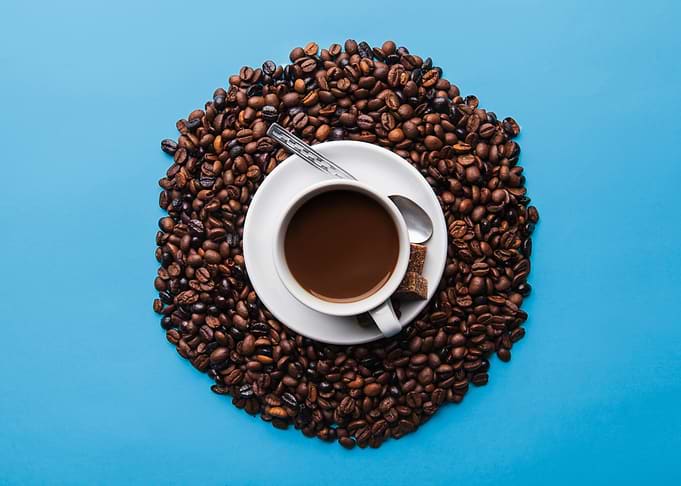 Coffee Cup Surrounded by Beans