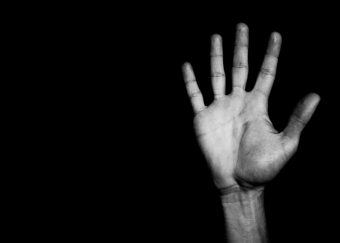 Open Human Hand Against Black Background