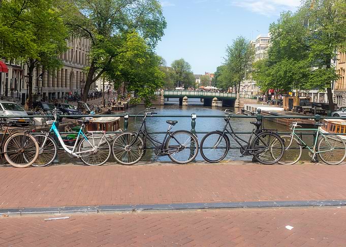 Bicycles parked on Amsterdam canal bridge