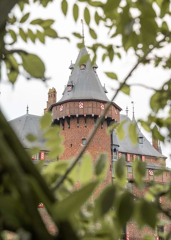 Castle De Haar Tower Through Green Foliage