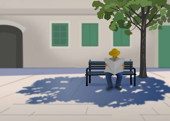 Man Reading Newspaper on a Bench
