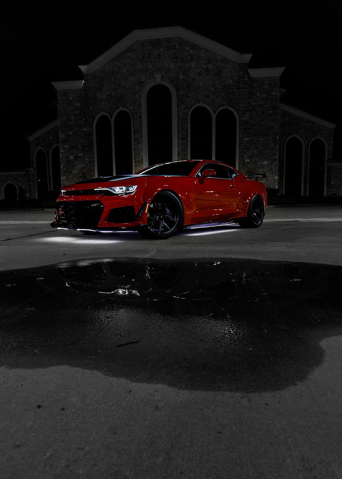 Red Chevrolet Camaro at Night
