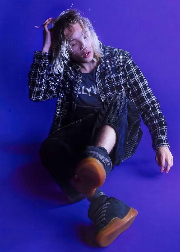 Young man in plaid shirt posing