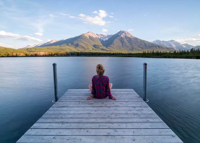 Woman sitting on a wooden dock
