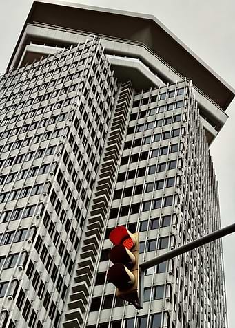 Modern Skyscraper with Red Traffic Light