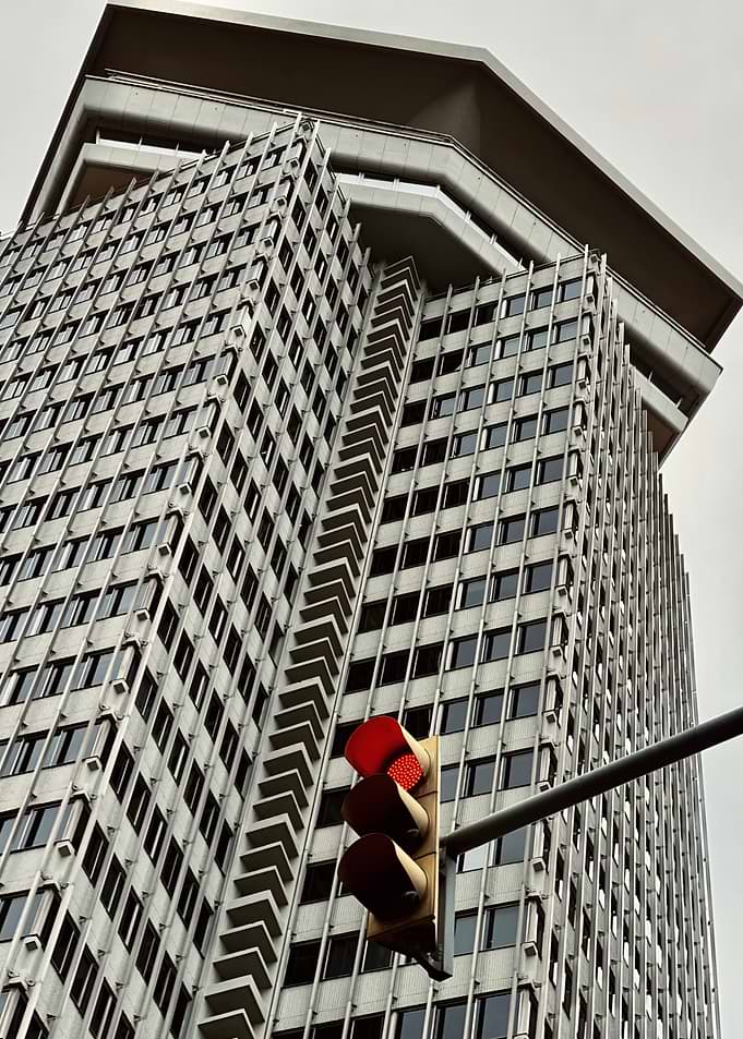 Modern Skyscraper with Red Traffic Light