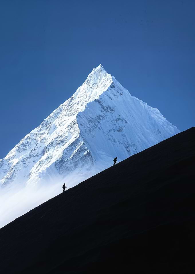 Climbers Ascending a Snowy Mountain Peak