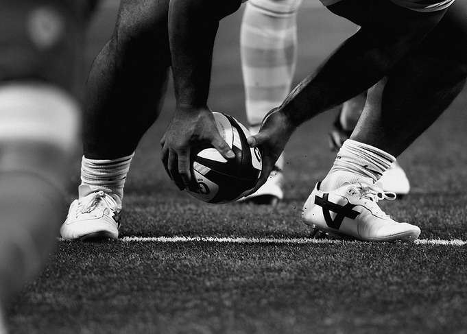 Rugby Player Placing Ball on Pitch
