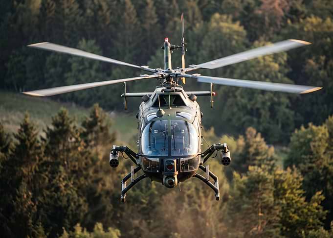 Military Helicopter Flying Over Forest