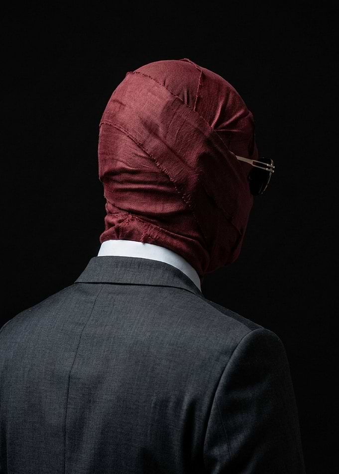 Man in Maroon Bandage Mask
