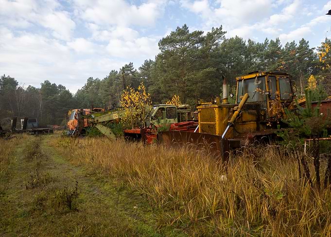 Abandoned Heavy Machinery in Overgrown Field