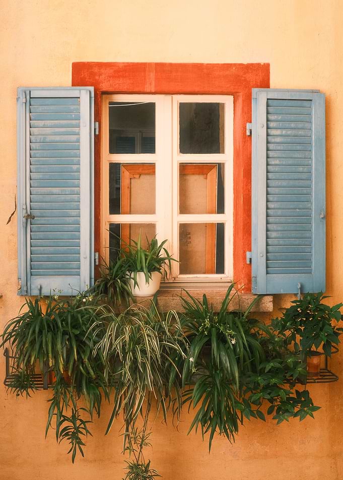 Mediterranean Window with Blue Shutters, Terracotta Wall, and Balcony Plants