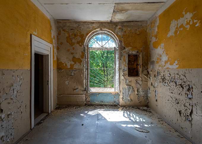 Abandoned Room with Arched Window