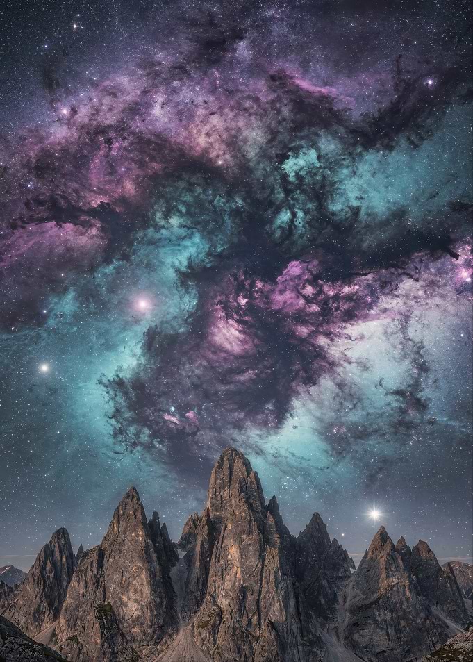 Majestic Mountain Peaks Under Cosmic Nebula