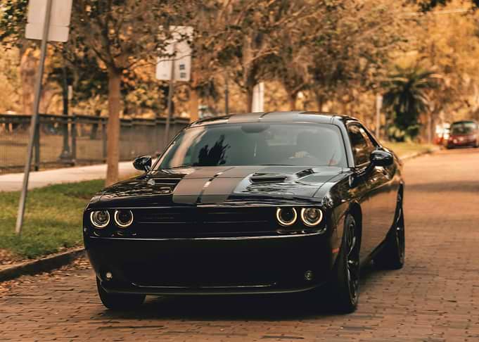 Black Dodge Challenger on Brick Road