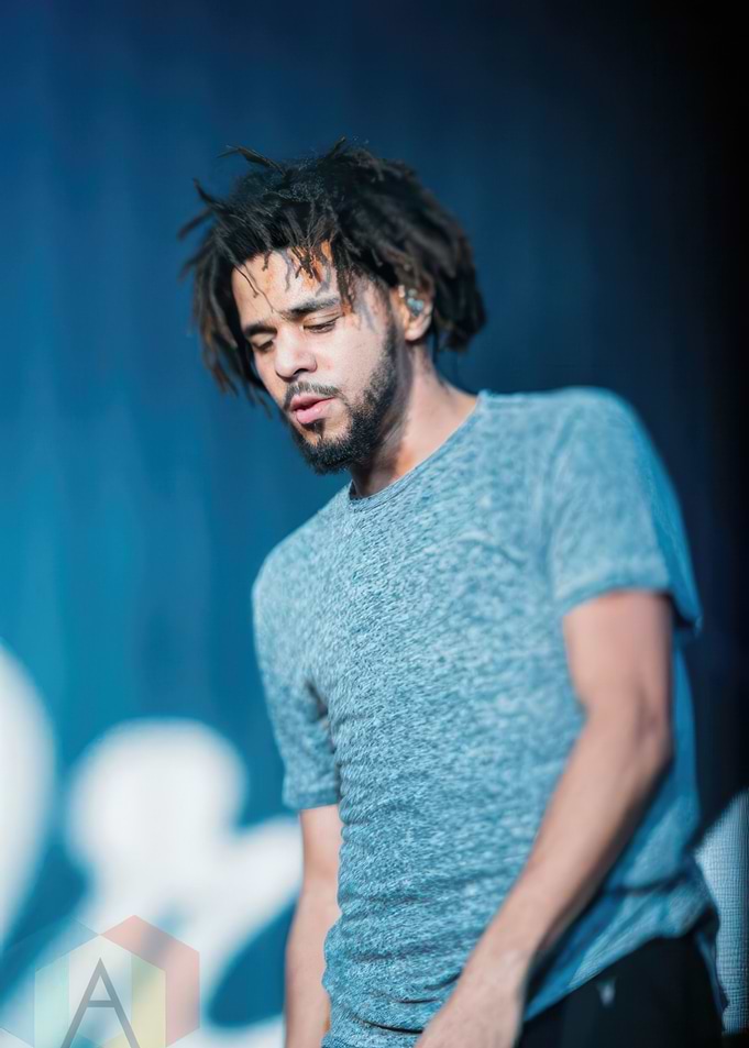 J. Cole performing on stage