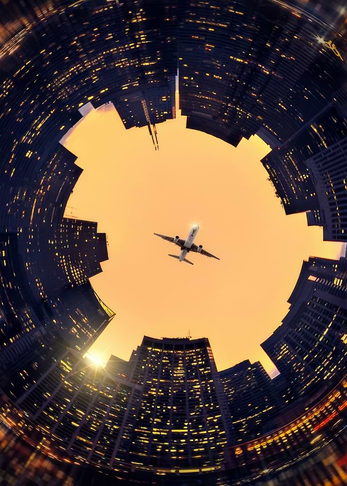 Airplane Flying Over Circular City Skyline