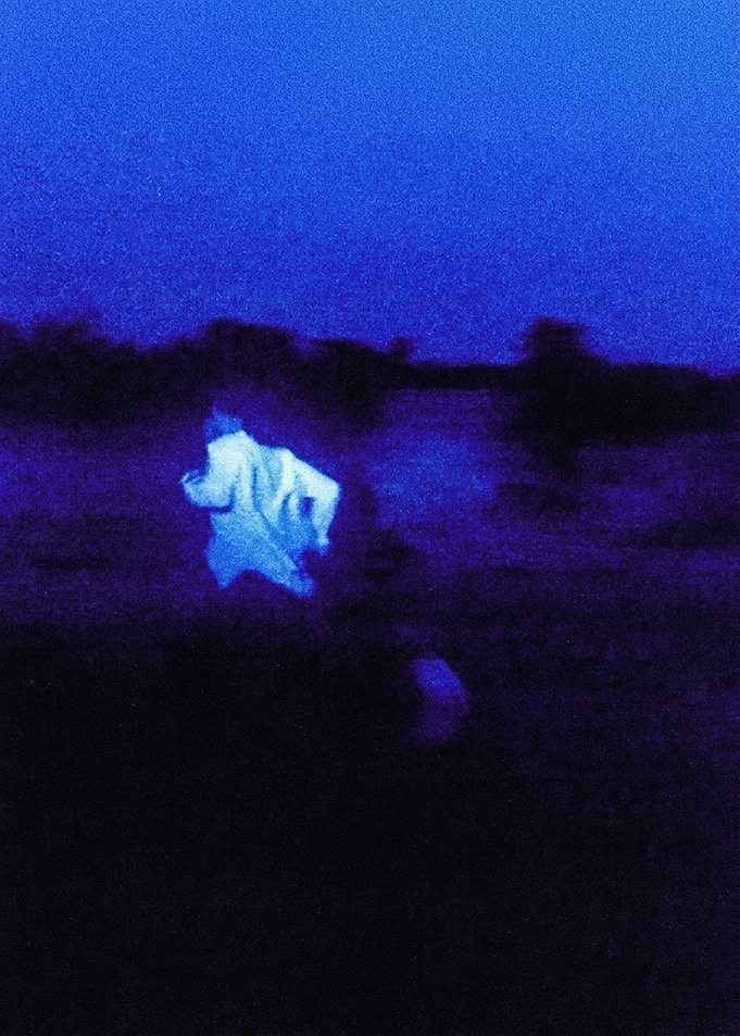 Blurry Figure Running in Blue Night