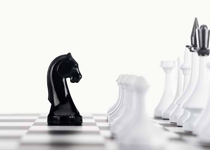 Chess Black Knight Facing White Chess Pieces
