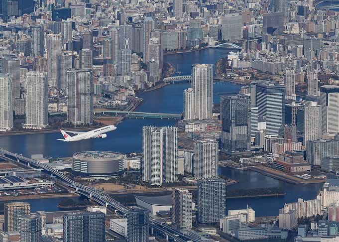 Japan Airlines Plane Over Tokyo Skyline
