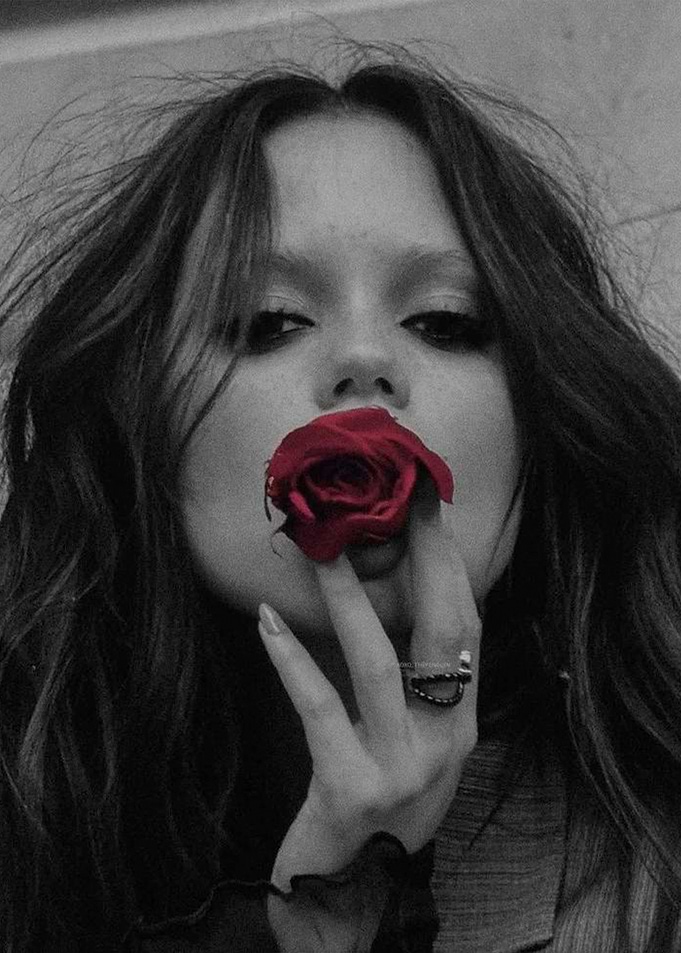 Jenna Ortega Holding Red Rose to Lips
