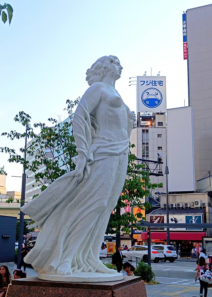 White Statue in Osaka Cityscape