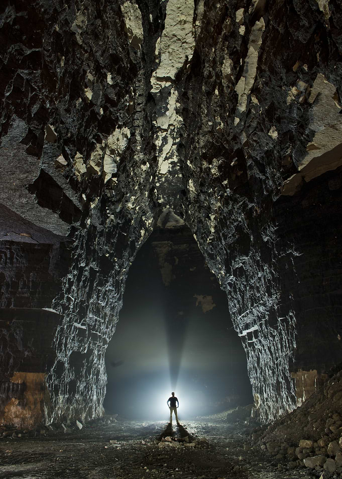 Explorer Standing in Vast underground Gypsum Mine