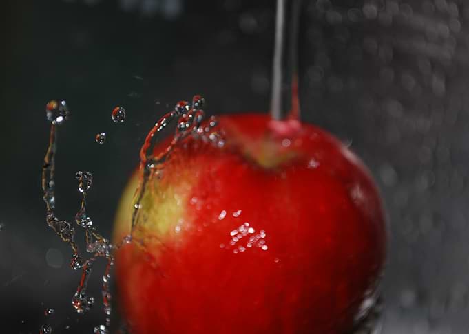 Red Apple Under Running Water